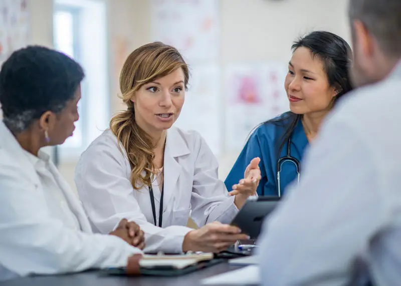 Clinicians talking with central famale
